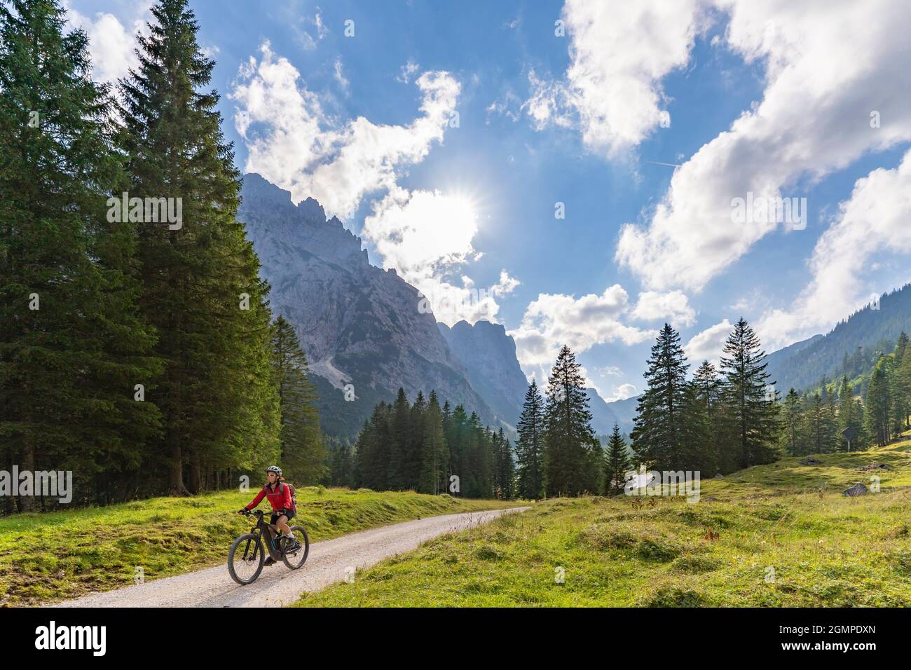 beautiful active senior woman with electric mountainbike in the spectacular Mountains of Raintal Valley, a side valley of Lechtal, Tyrol, Austria Stock Photo