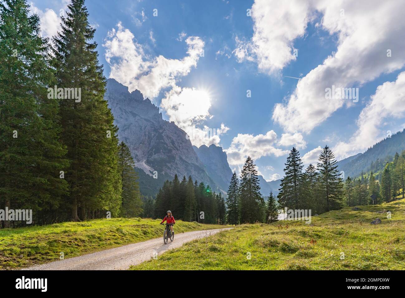 beautiful active senior woman with electric mountainbike in the spectacular Mountains of Raintal Valley, a side valley of Lechtal, Tyrol, Austria Stock Photo