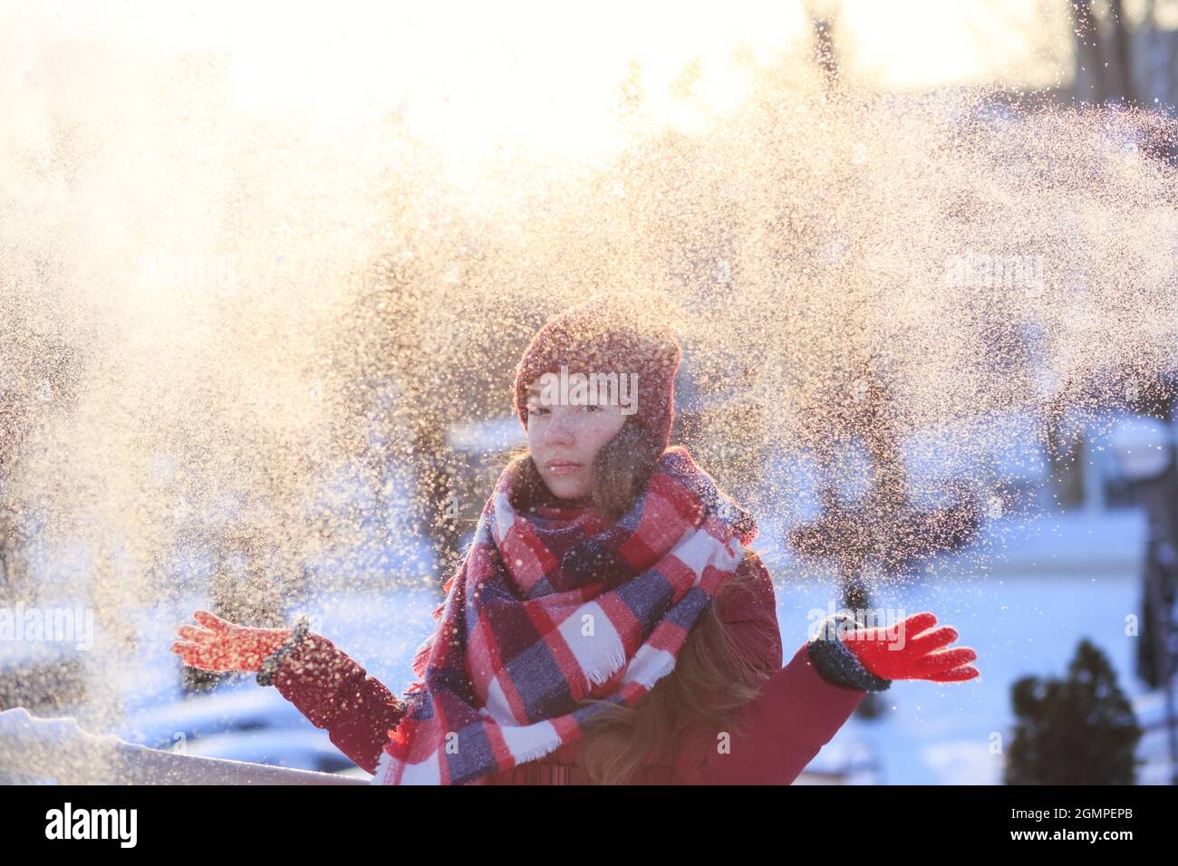 Winter teen girl portrait. Beauty Joyful Model Girl having fun in winter park. Enjoying nature, wintertime. Stock Photo