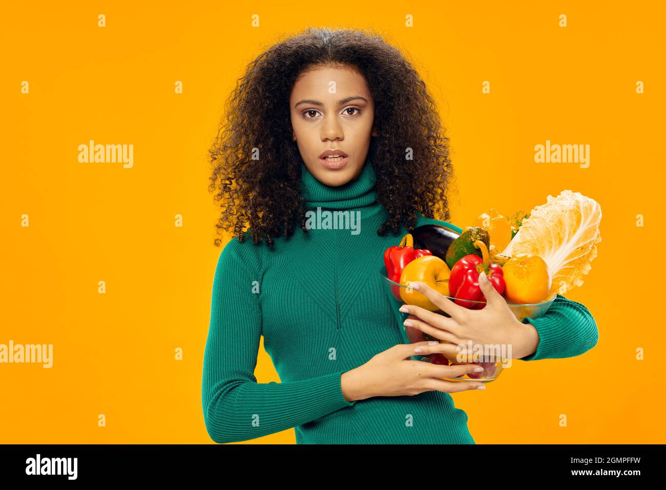 woman with curly hair foods vegetables diet food health Stock Photo - Alamy