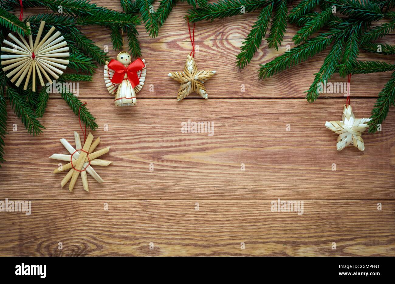 Christmas wooden background with branches of fir tree and straw ...
