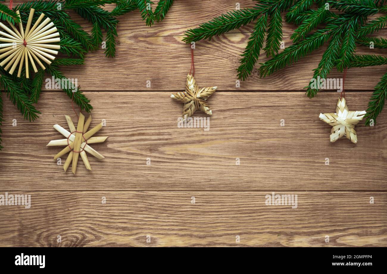 Christmas wooden background with branches of fir tree and straw ...