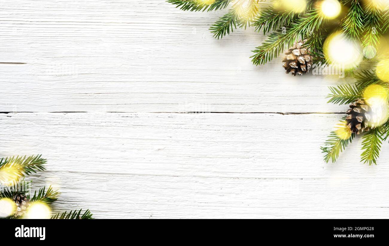 Christmas tree branches and pine cones on white wooden background Stock ...
