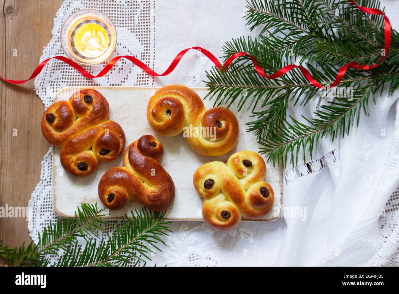 Traditional Swedish saffron buns of various shapes on a light background. Stock Photo