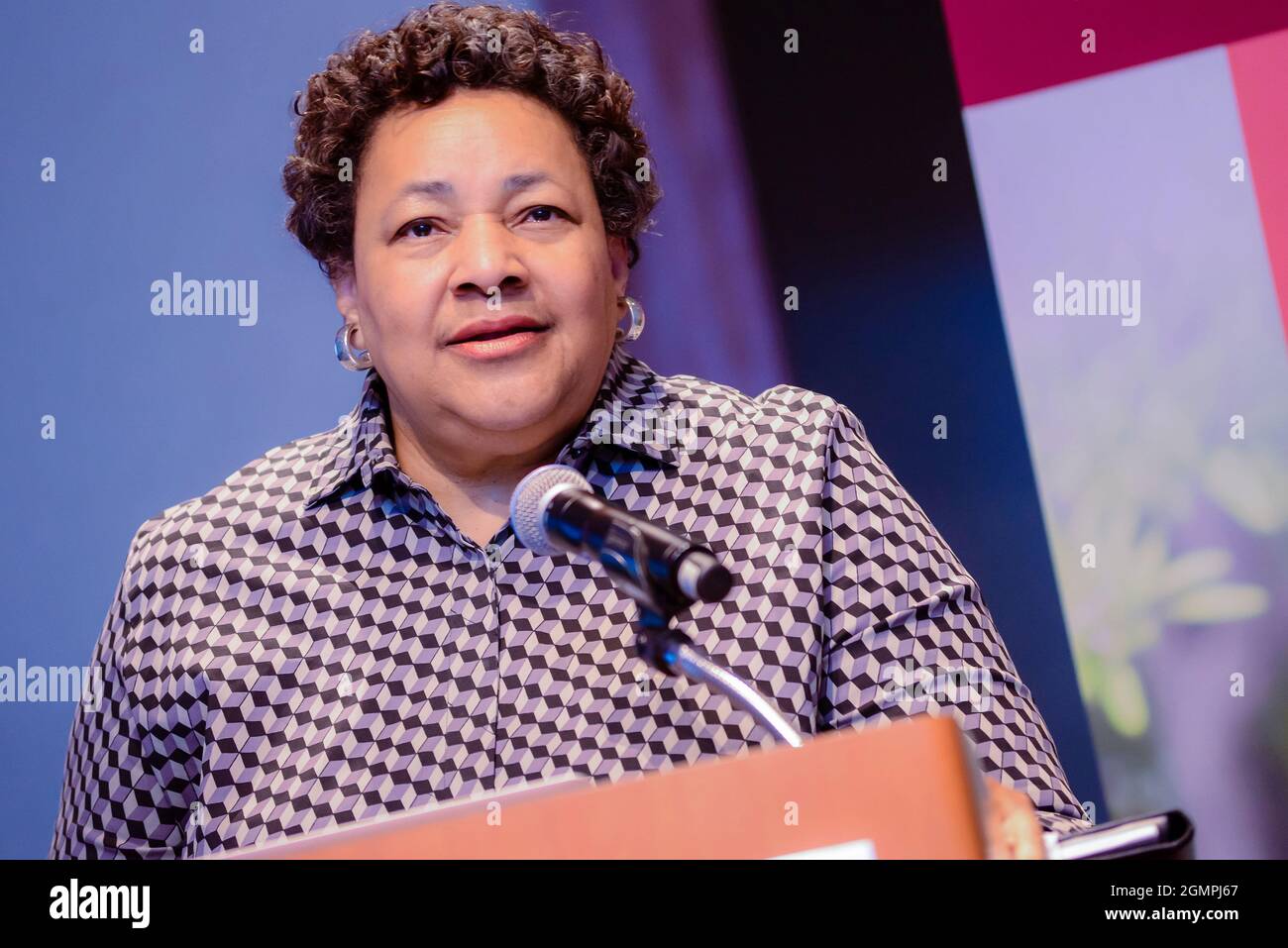 Older african american woman with short curly hair speaking at a podium ...