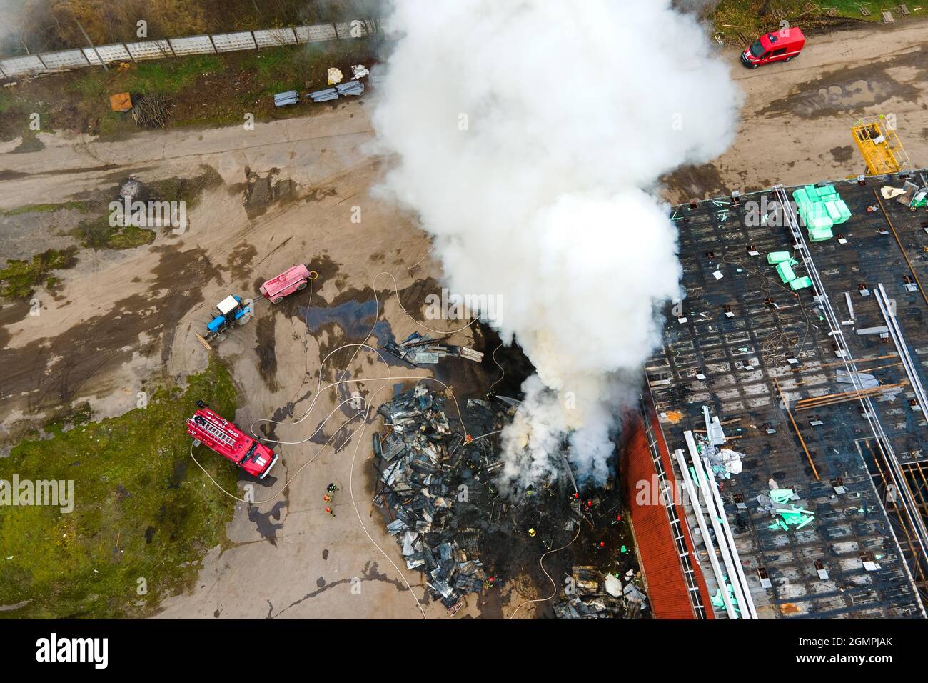 Aerial view of firefighters extinguishing fire in industrial area Stock ...