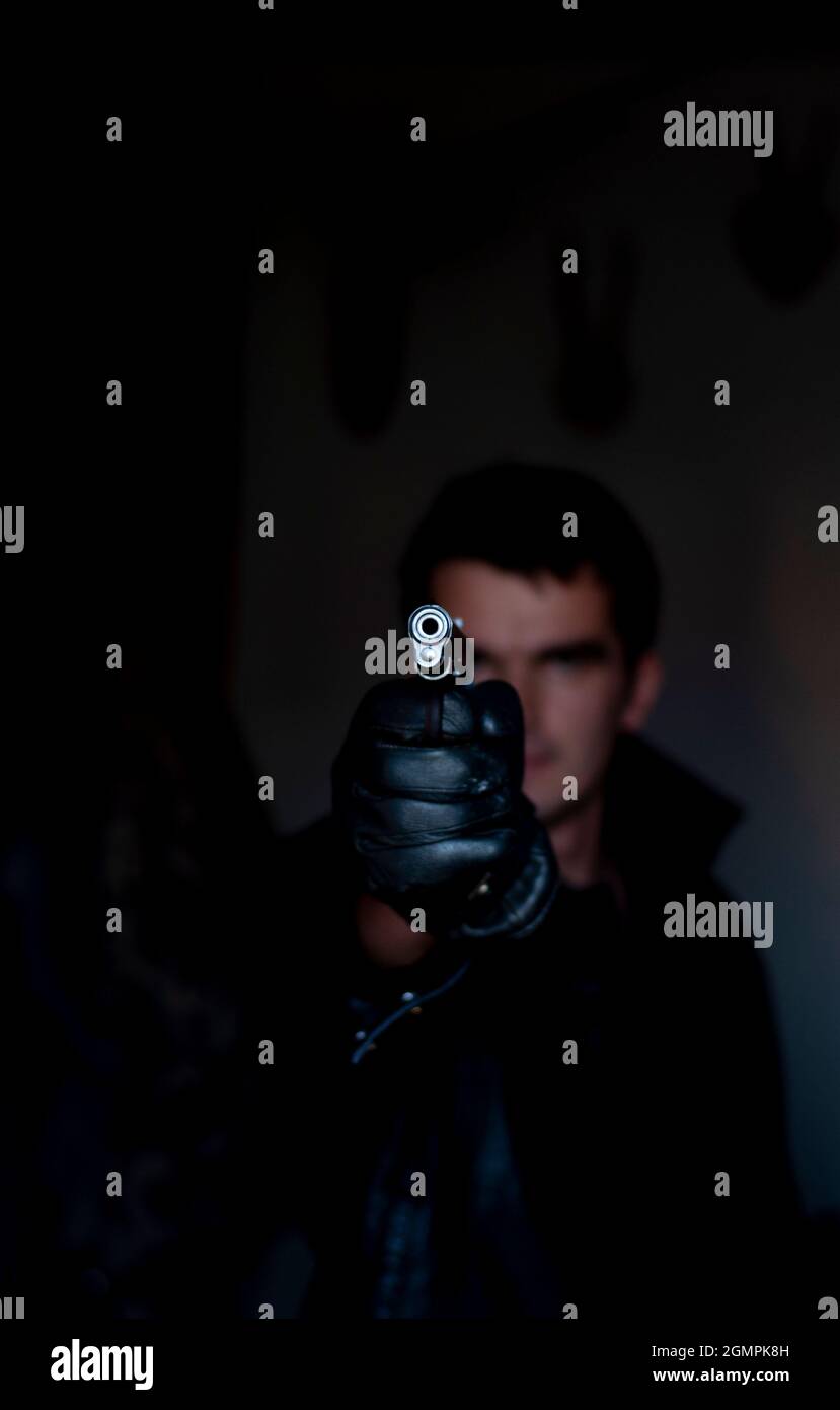man holding a gun Stock Photo - Alamy