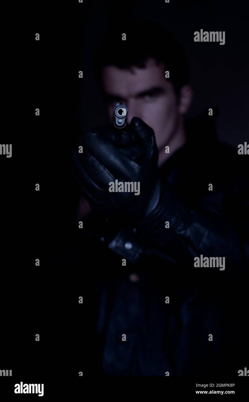 man holding a gun Stock Photo - Alamy