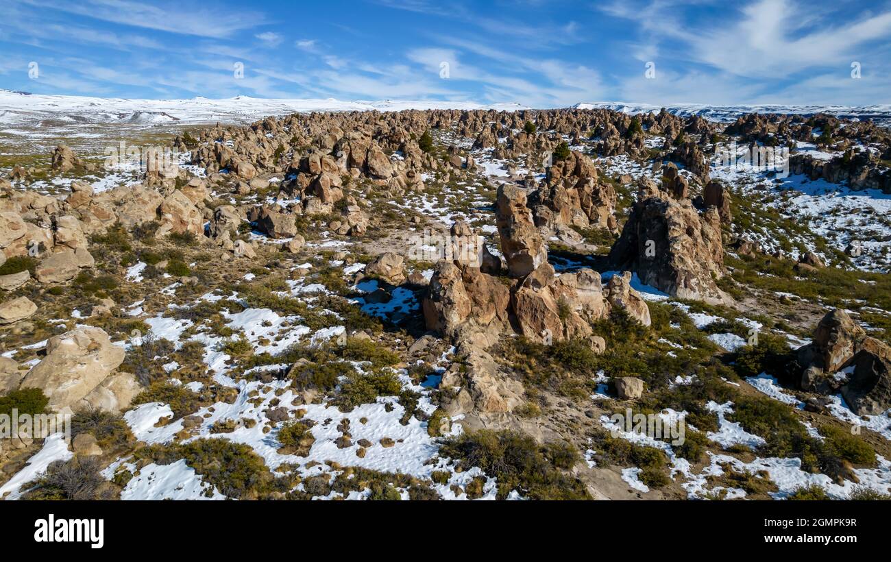 Aerial view of ignimbrite rock field with snow in the Andes mountain
