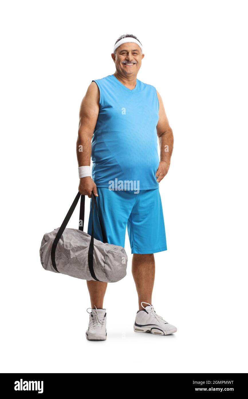 Full length portrait of a mature man in sportswear holding a sports bag isolated on white background Stock Photo