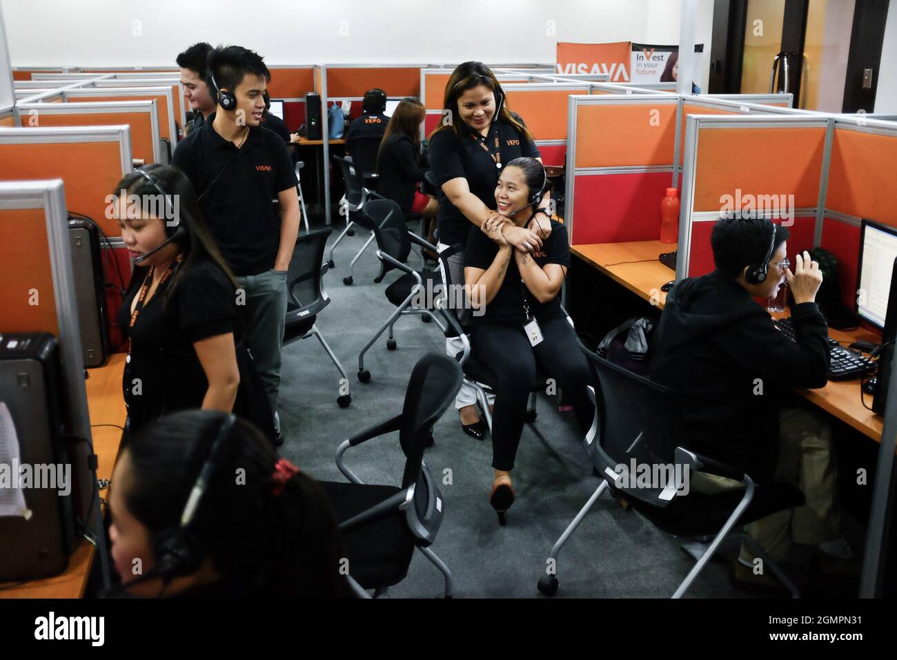 Customer Service Representatives at the Visaya Knowledge Process Outsourcing (VKPO) call center, in Makati, during the night shift. Stock Photo