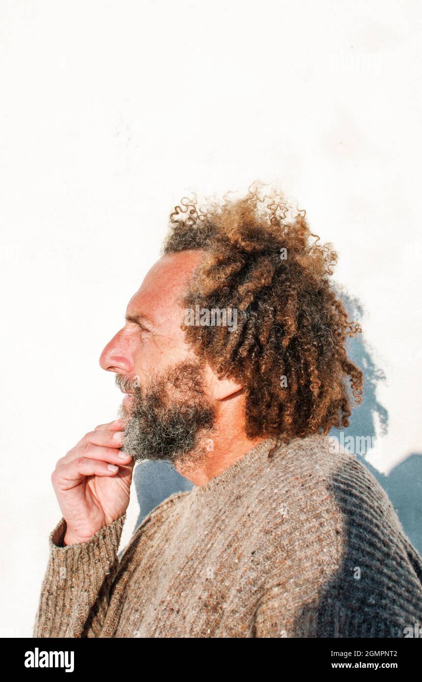 Man with curly hair and beard hi-res stock photography and images - Alamy