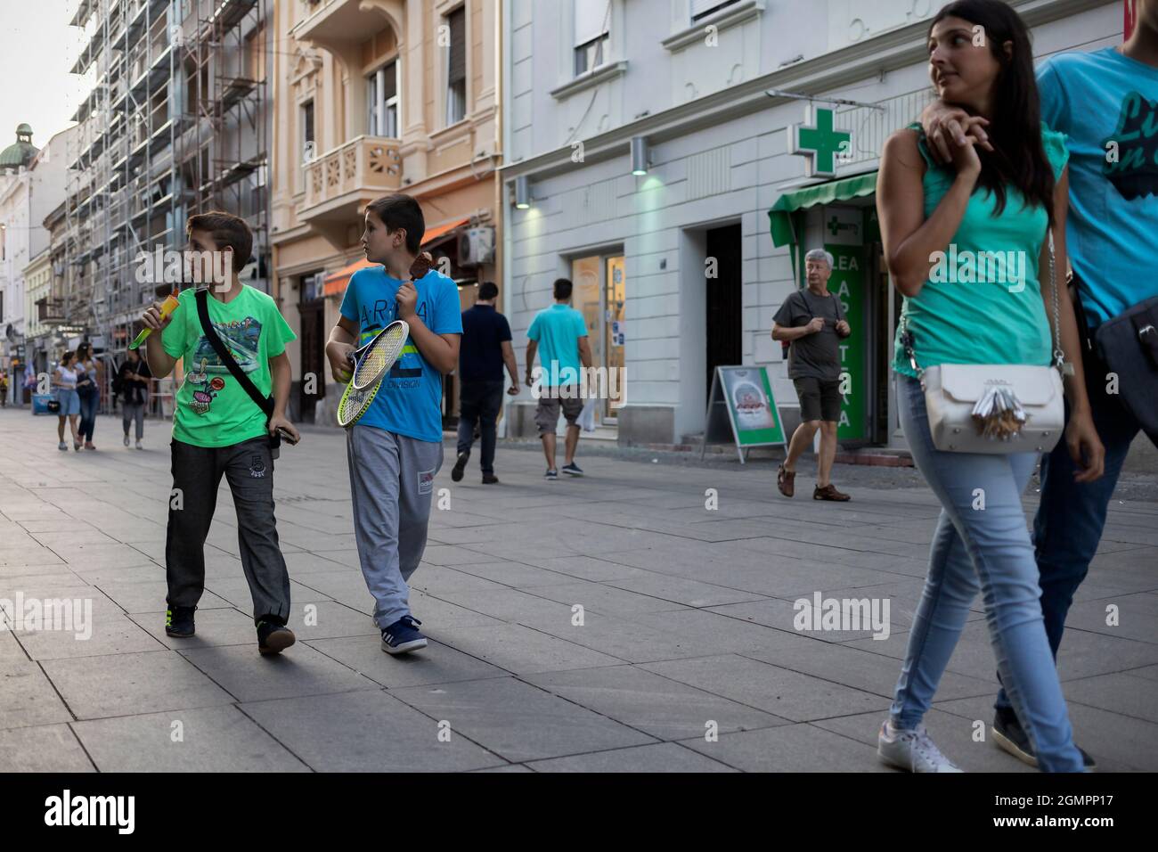 Belgrade, Serbia, Sep 10, 2019: A street scene with people walking forward while being distracted to their right Stock Photo