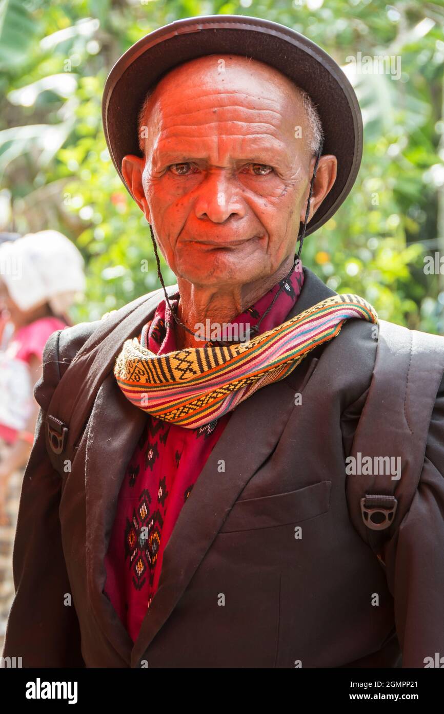 Portrait of a Tetum man wearing ikat clothes and black western jacket and hat in Oinlasi village, West Timor, Indonesia Stock Photo