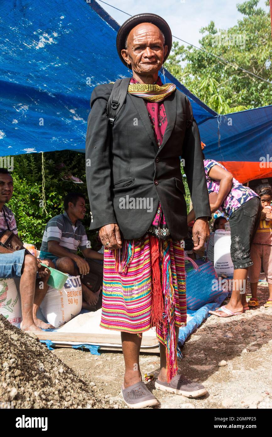 Portrait of a Tetum man wearing ikat clothes and black western jacket and hat in Oinlasi village, West Timor, Indonesia Stock Photo