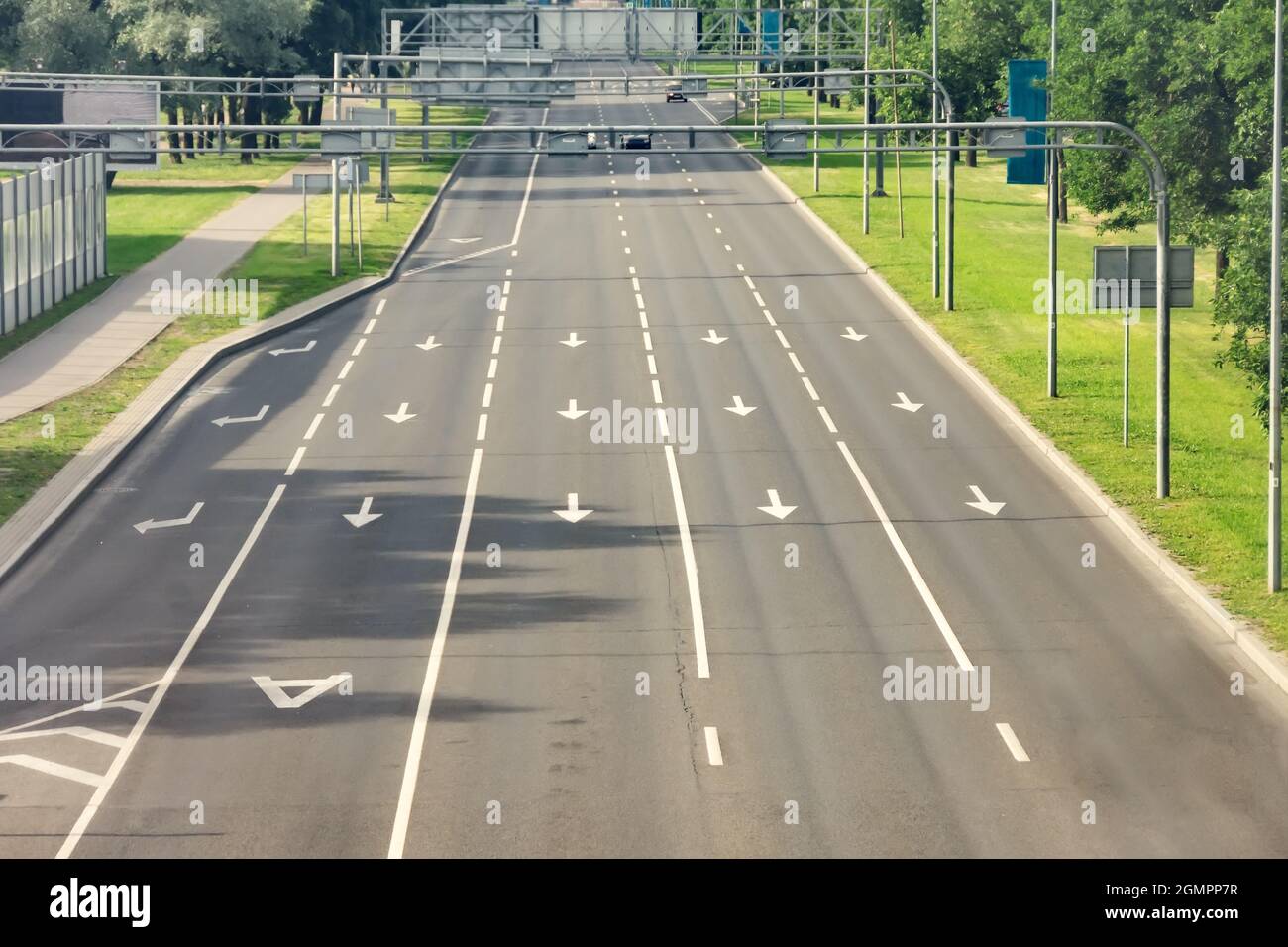 Arrow signs as road markings on a street with five lanes. Dedicated