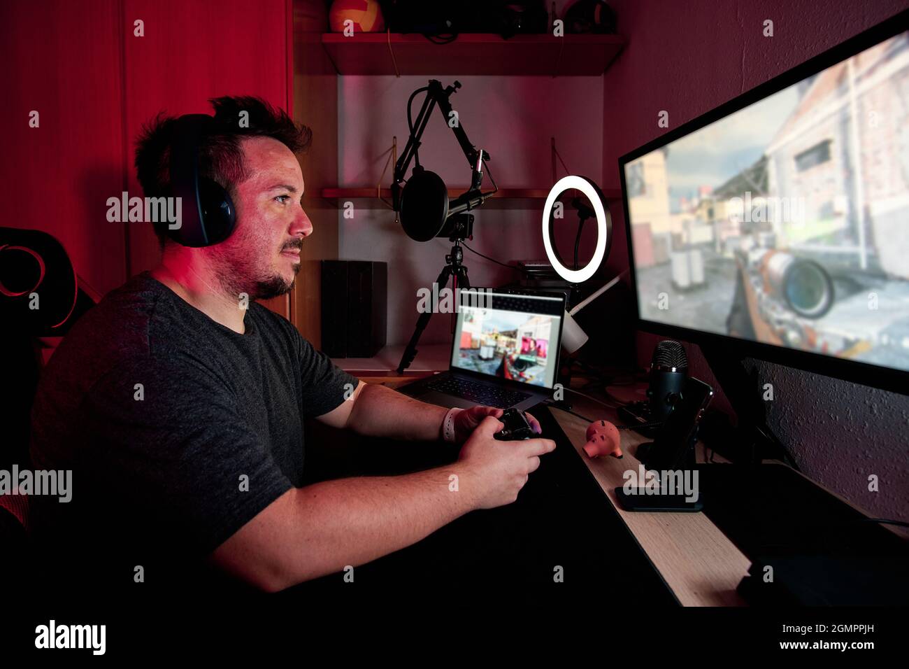 Gamer Using Mic a gamer playing and streaming live with microphones and cameras Stock ...
