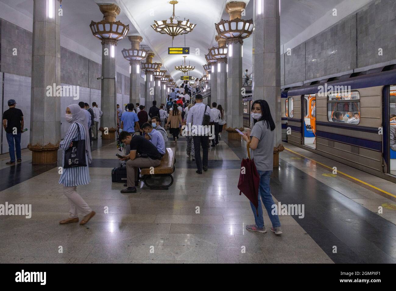 passengers waiting for train at Yunus Rajabiy station, Tashkent metro, Uzbekistan Stock Photo