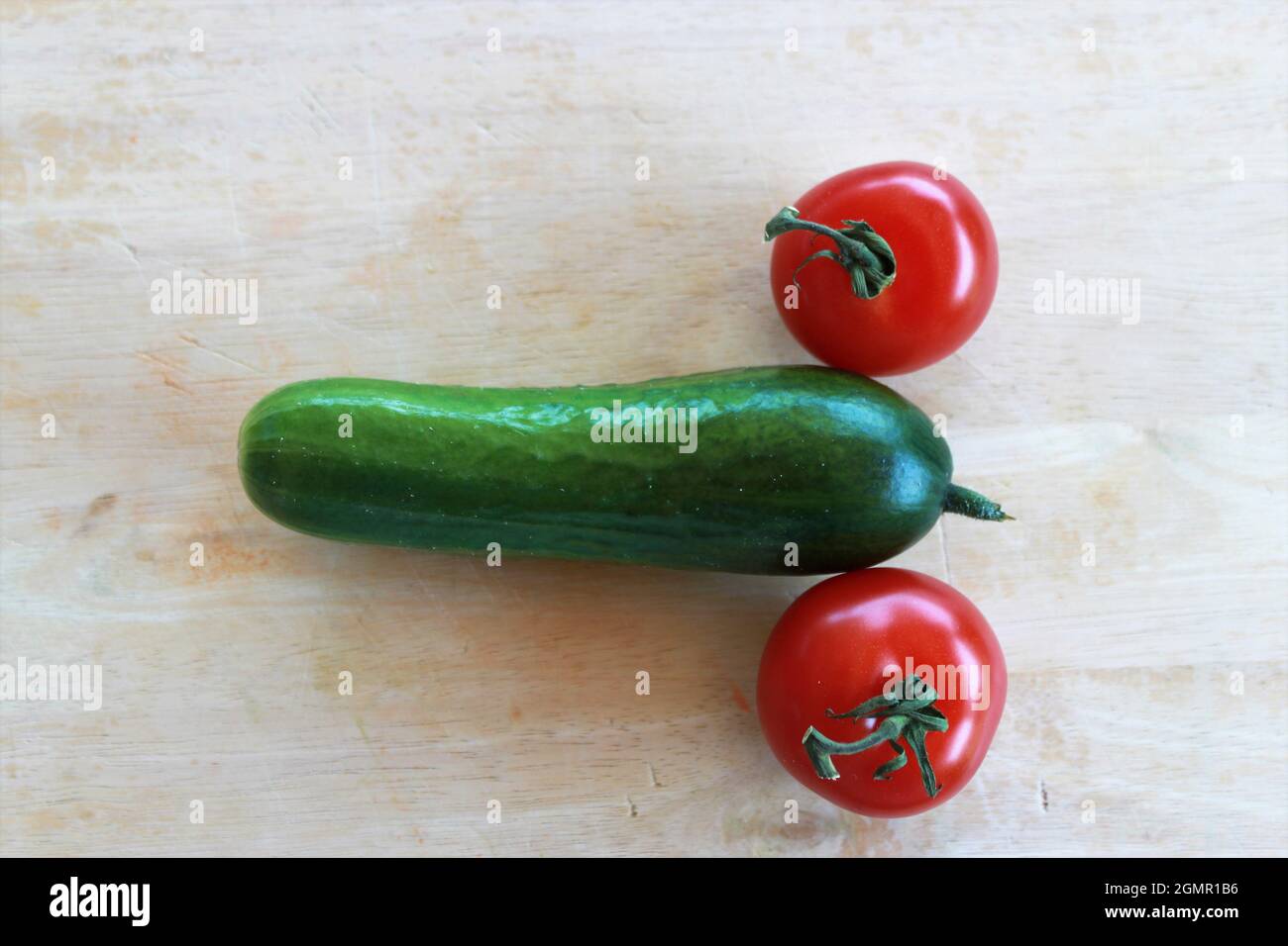 Vegetables in the form of cucumbers and tomatoes  symbolize Stock Photo