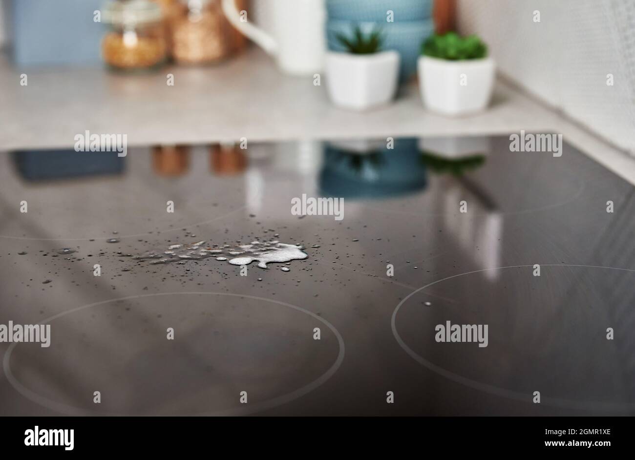 Cleaning induction stove. Cleaning spray on induction hob. Clear