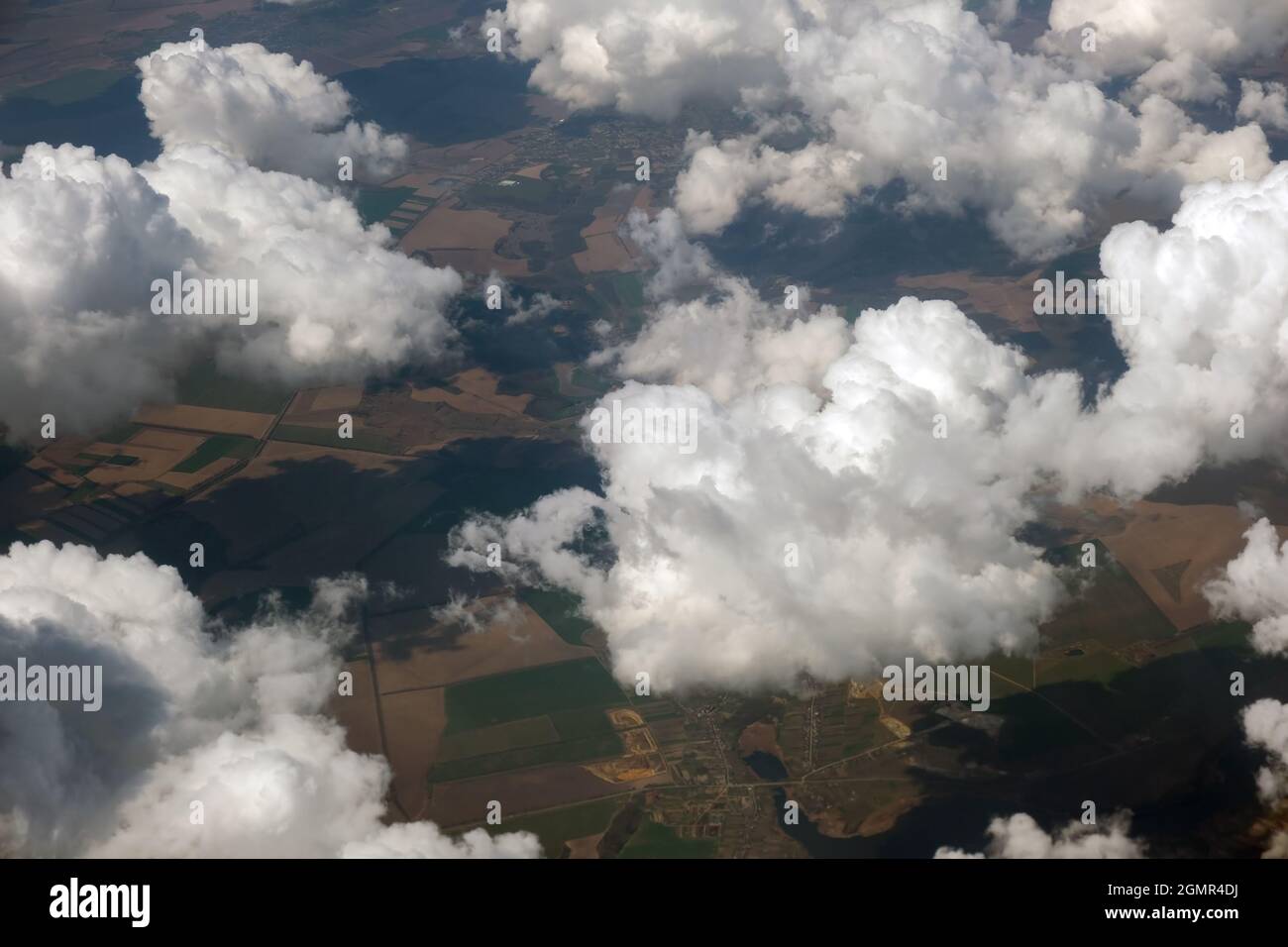 Aerial view from airplane window of white puffy clouds on bright sunny ...