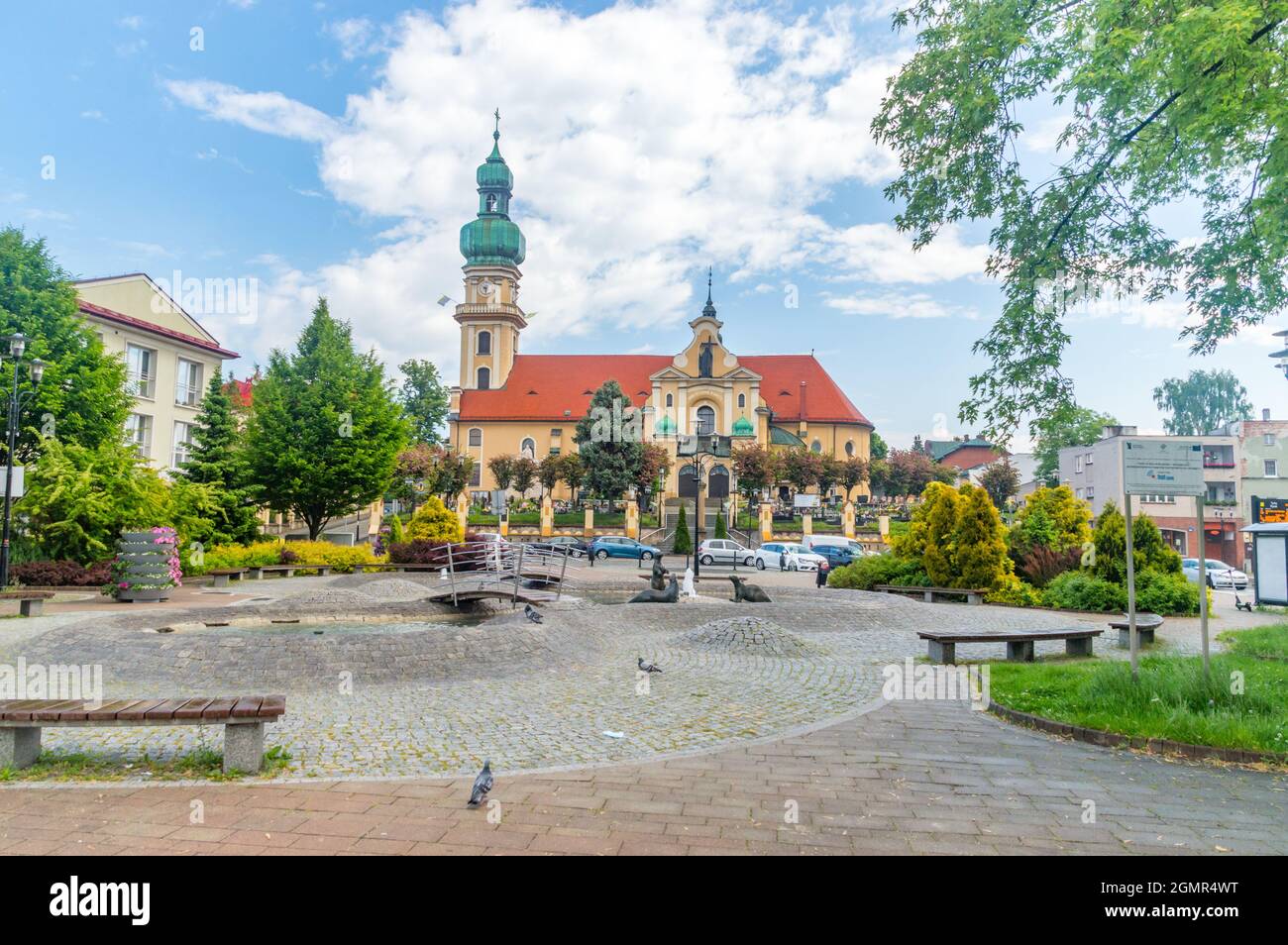 Tychy, Poland - June 5, 2021: Market square with fountain with Otters and St. Mary Magdalene church in background. Stock Photo