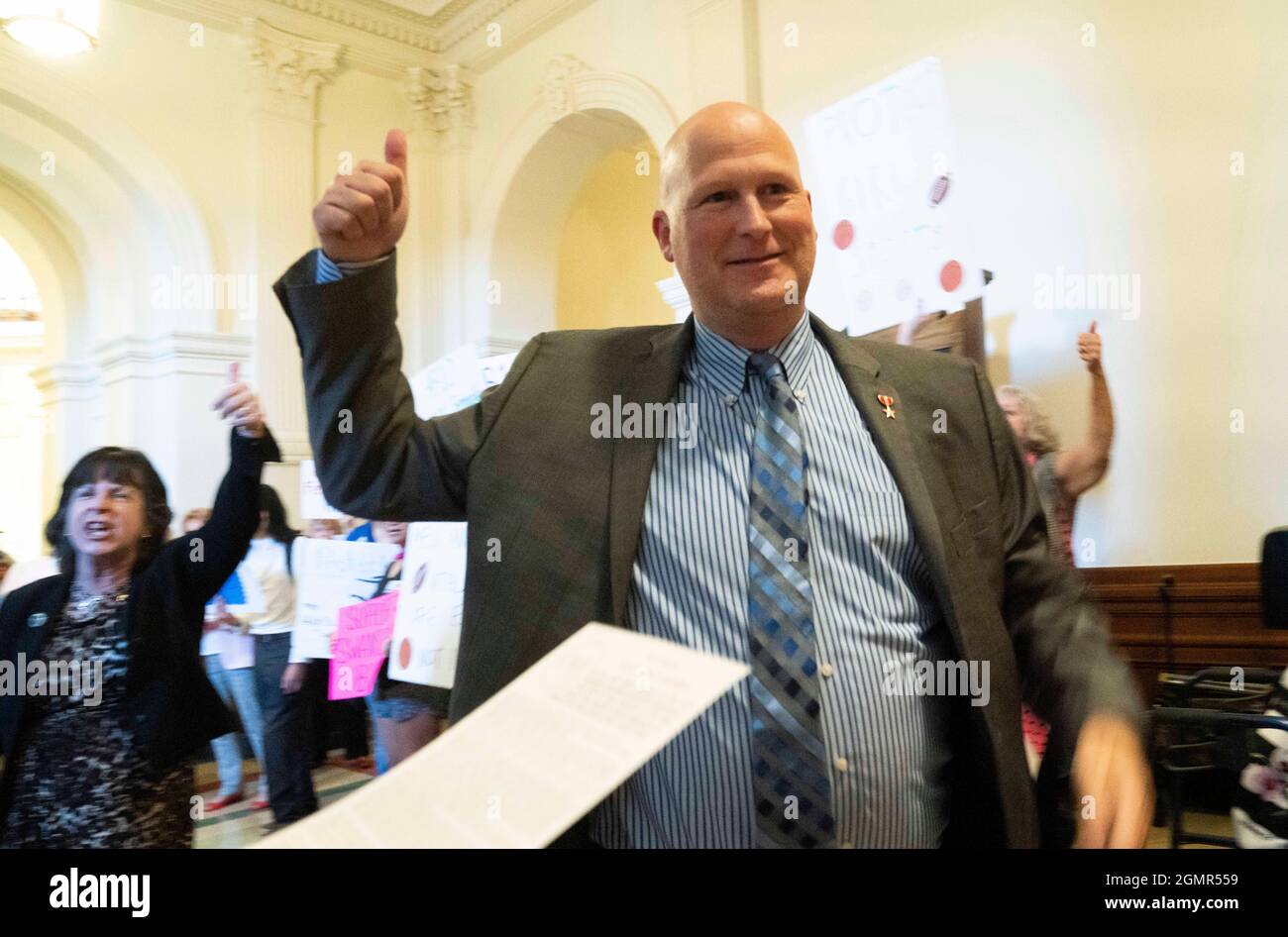Texas, USA. 20th Sep 2021. Rep. Tony Tinderholt, R-Arlington, enters the House chamber as a group advocating for a ban on transgender athletes competing in girls sports greets legislators outside the Texas House chamber on the first day of the third called special session.  Credit: Bob Daemmrich/Alamy Live News Stock Photo