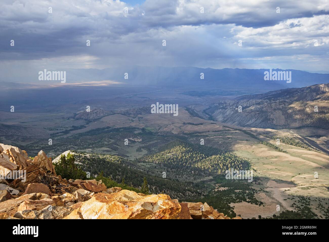 summer shower over Bishop California in the Owens Valley seen from Bishop Bowl Peak Stock Photo
