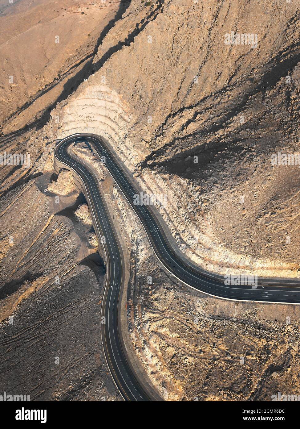 Aerial view of Jebel Jais mountain desert highway road surrounded by sandstones in Ras al Khaimah emirate of the United Arab Emirates Stock Photo