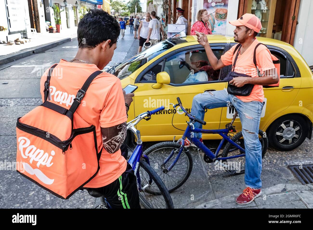 Cartagena Colombia,Center centre Centro,Rappi on-demand delivery startup,Hispanic men male bicycle riders bike messengers couriers Stock Photo