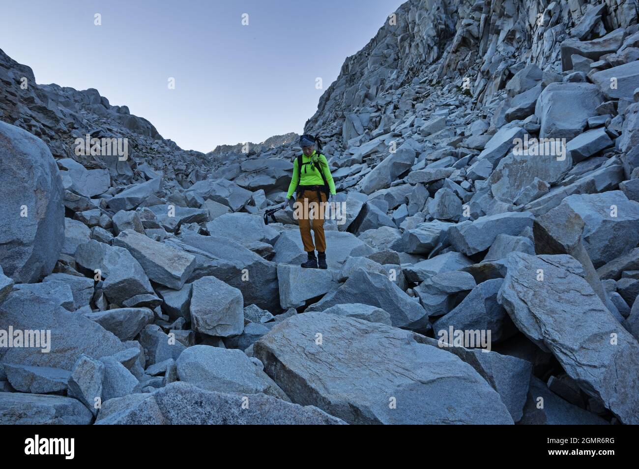 Asian woman hiking on a boulder field in the Sierra Nevada Mountains Stock Photo