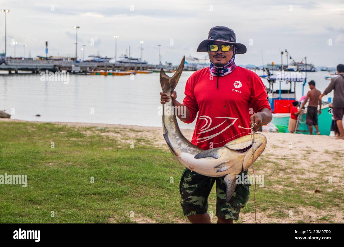 Thai fisherman with his freshly caught eel tail catfish in Pattaya District Chonburi Thailand Stock Photo