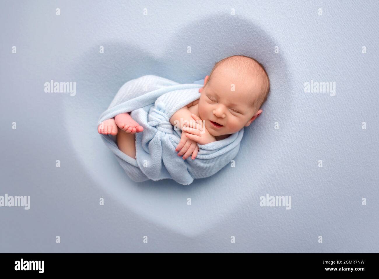 Newborn baby in a blue cocoon Stock Photo Alamy