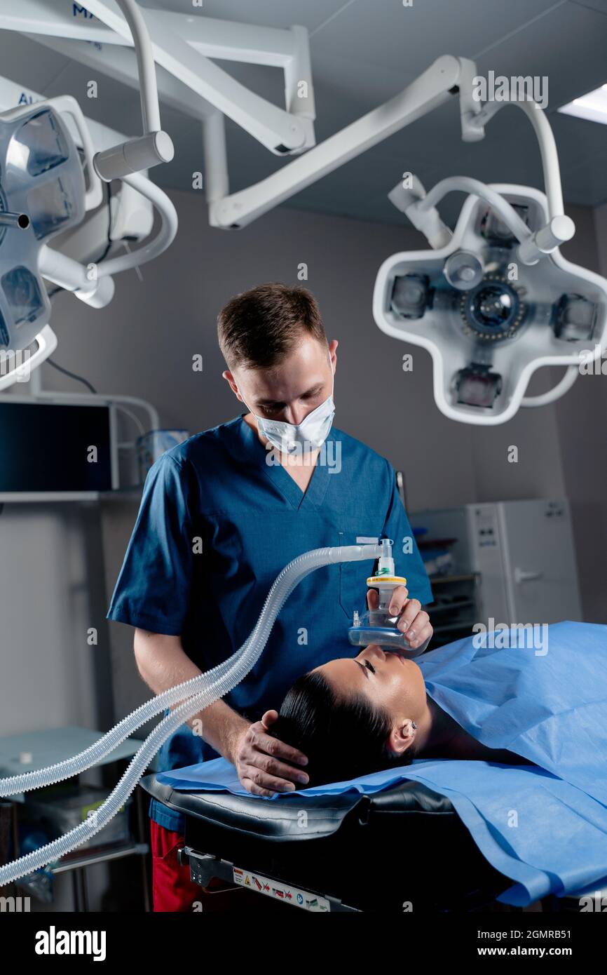 Anesthesiologist making ingalation anesthesia for patient. Doctor puts