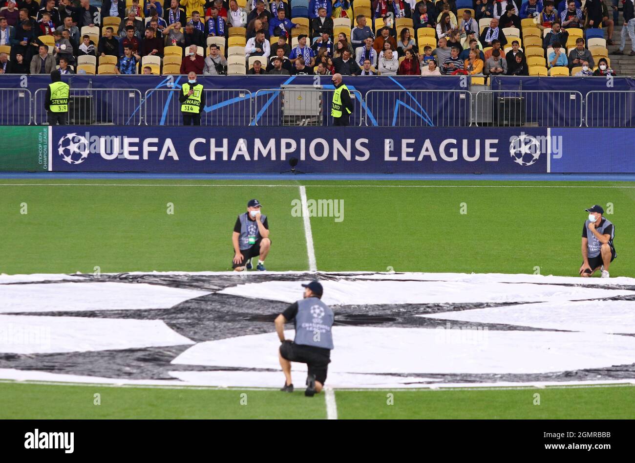 KYIV, UKRAINE - SEPTEMBER 14,2021: Pitch of NSK Olimpiyskiy stadium with UEFA Champions League official logo in centre circle and billboard seen during UEFA Champions League game Dynamo Kyiv v Benfica Stock Photo