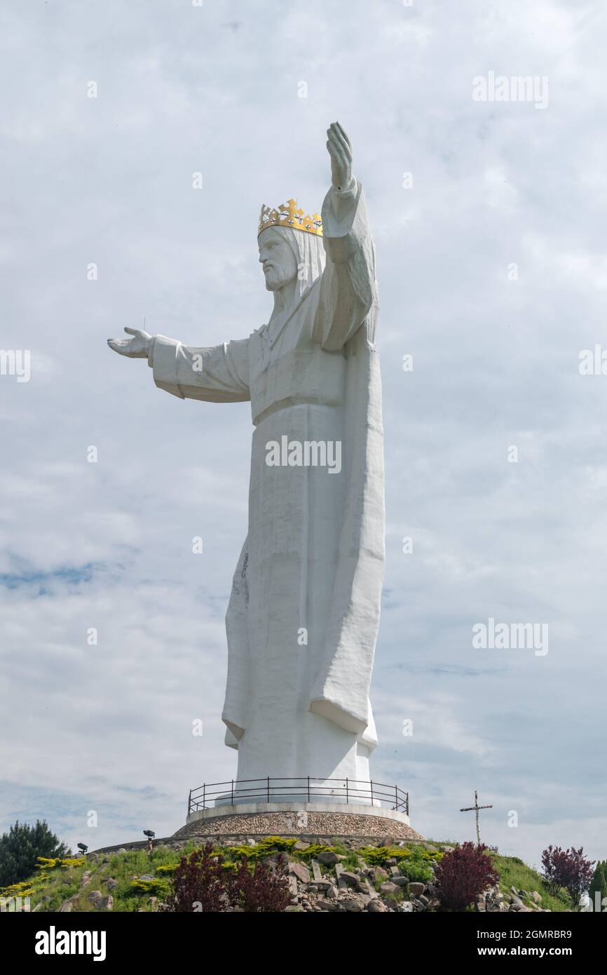 Statue of Christ the King with clouds in background. 33 meter high statue of the Jesus Christ figure, in Swiebodzin. Stock Photo