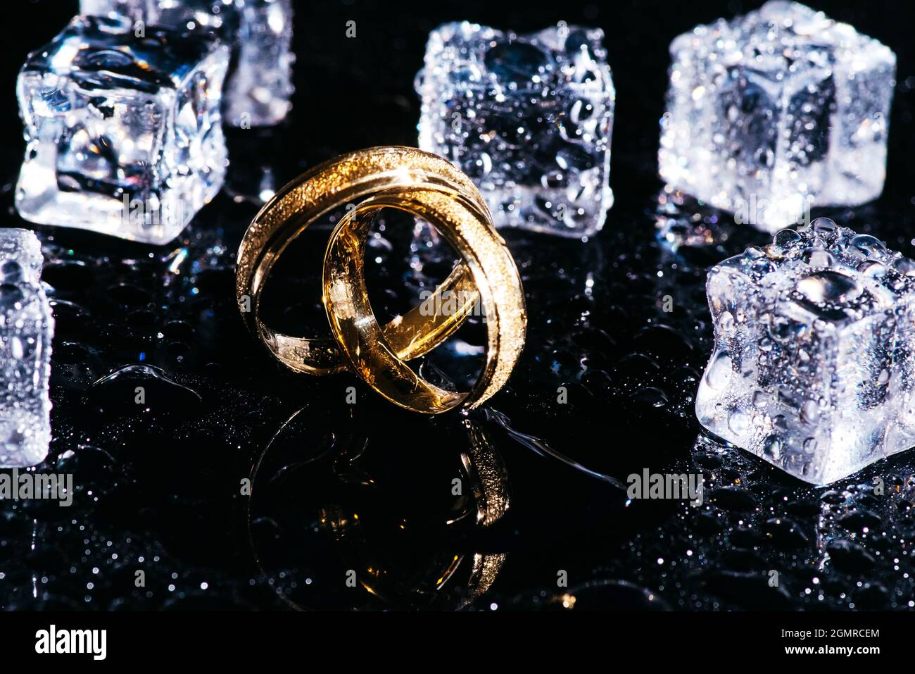 Wedding concept.Wedding rings and ice cubes. Background for greeting ...