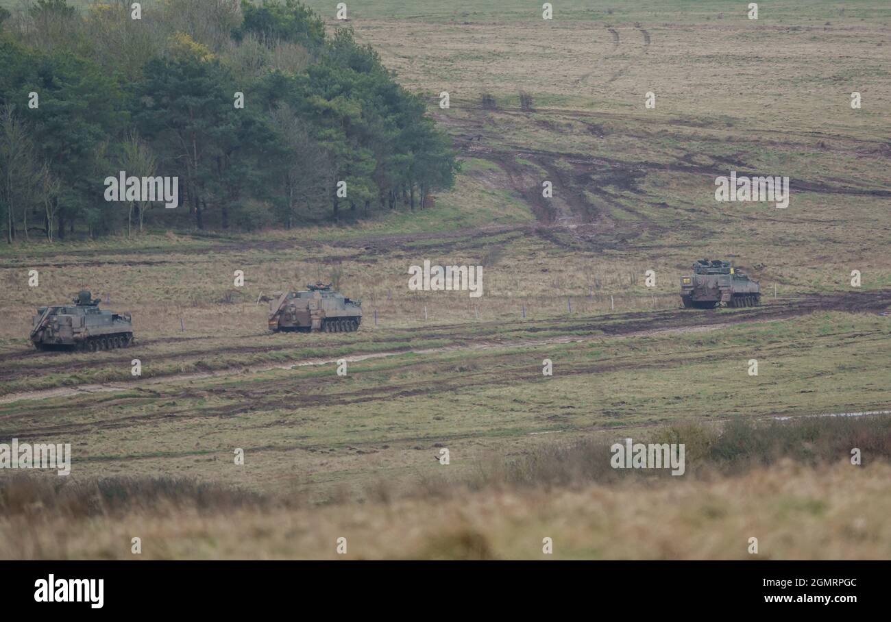 British army Warrior FV512 MRV & Warrior FV510 IFV tanks in action on a military exercise, Salisbury Plain, Wilts UK Stock Photo