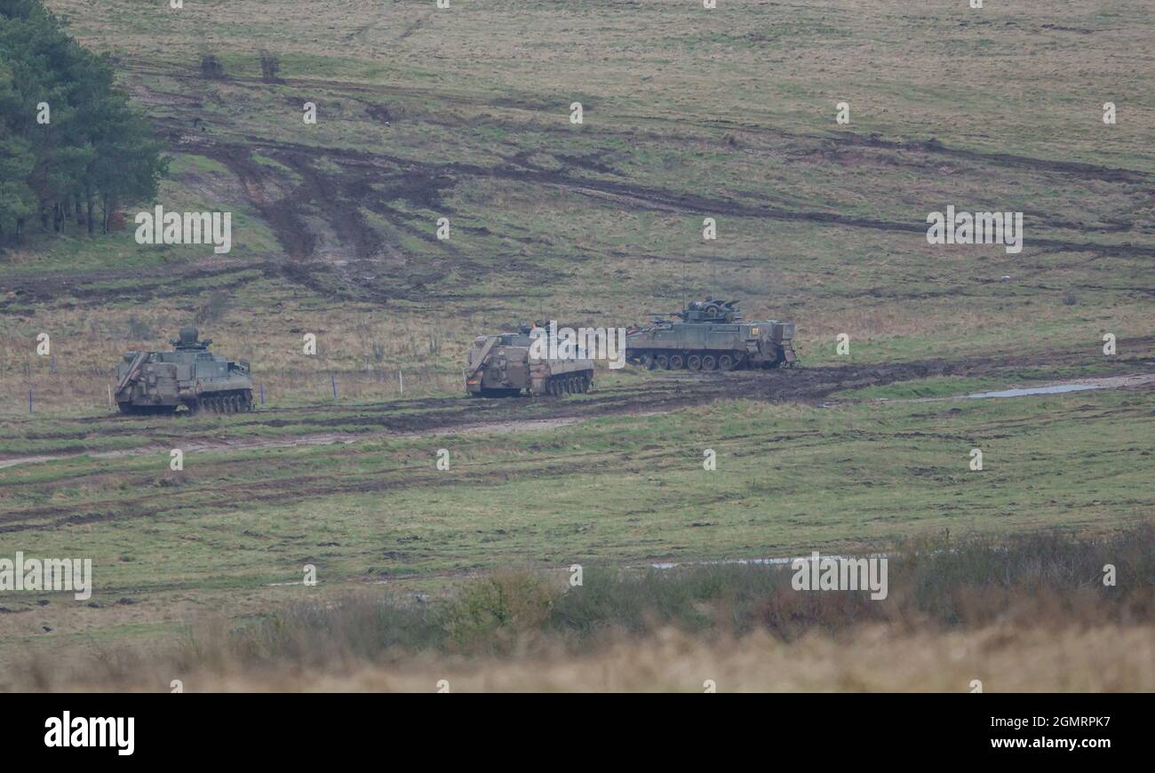 British army Warrior FV512 MRV & Warrior FV510 IFV tanks in action on a military exercise, Salisbury Plain, Wilts UK Stock Photo