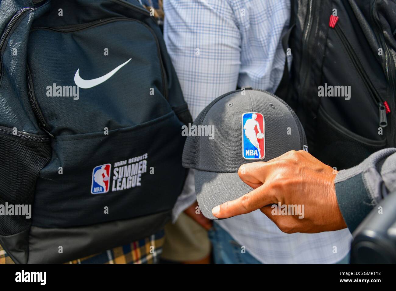 A photographer holds a hat with the NBA logo next to a Nike backpack embroidered with NBA Summer League during a groundbreaking ceremony for the new h Stock Photo
