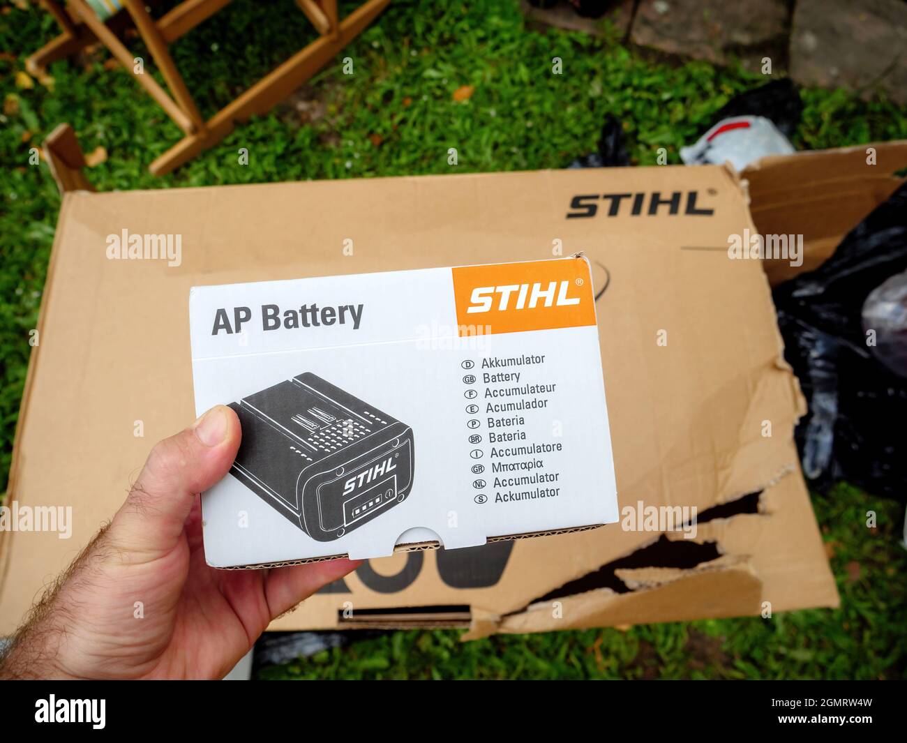 Pov male hand holding carton package with Stihl Ap Battery Stock Photo -  Alamy