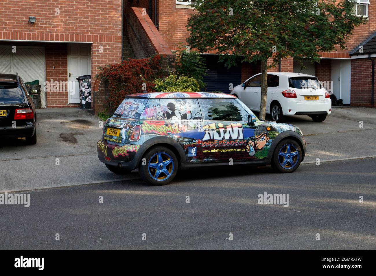Mini car wrapped to advertise car sales company Stock Photo Alamy