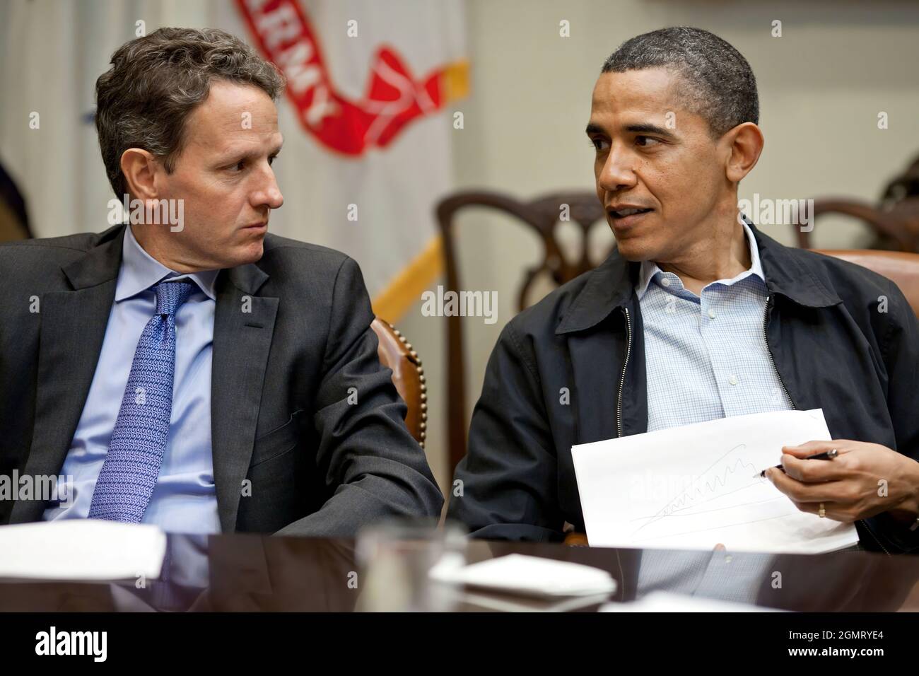 President Barack Obama talks with Treasury Secretary Timothy Geithner during fiscal policy meeting in the Roosevelt Room of the White House, Saturday, April 9, 2011. (Official White House Photo by Pete Souza) This official White House photograph is being made available only for publication by news organizations and/or for personal use printing by the subject(s) of the photograph. The photograph may not be manipulated in any way and may not be used in commercial or political materials, advertisements, emails, products, promotions that in any way suggests approval or endorsement of the President Stock Photo