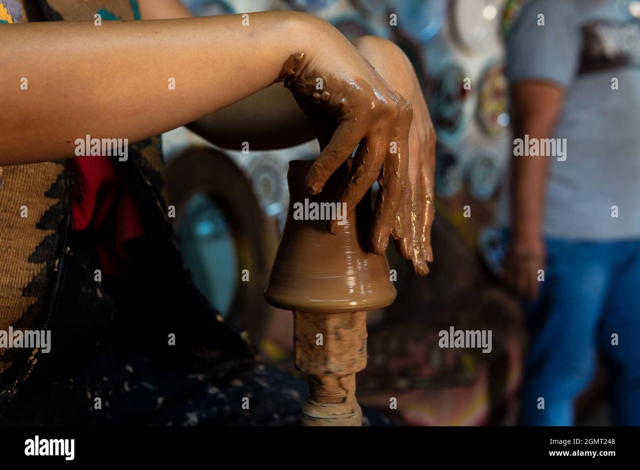 Pottery making, young woman learning to make pottery, a woman trying to