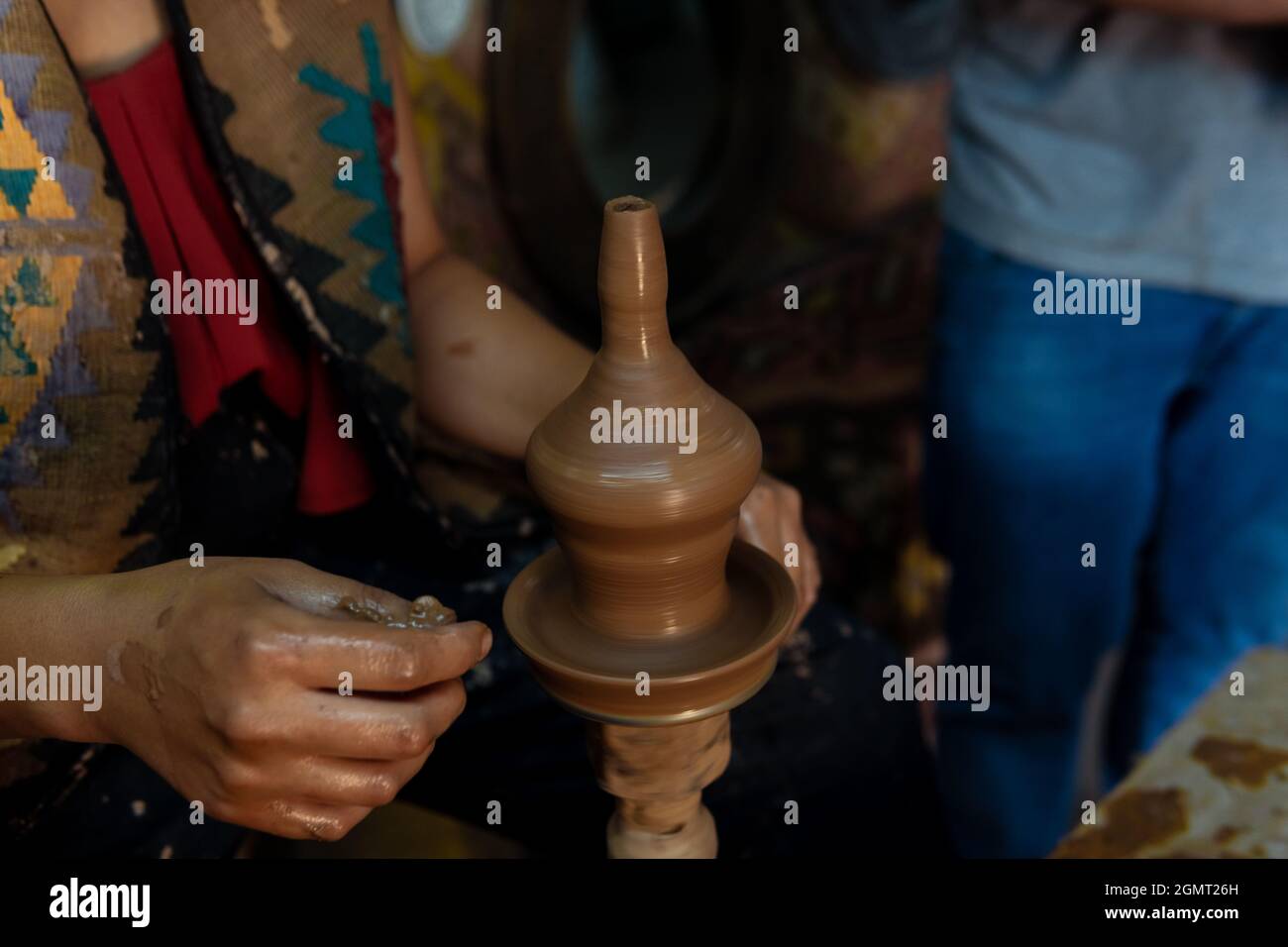 Pottery making, young woman learning to make pottery, a woman trying to