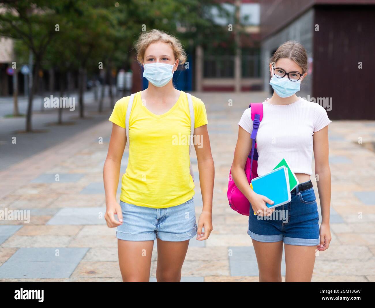Two young girls in face masks outdoors Stock Photo - Alamy