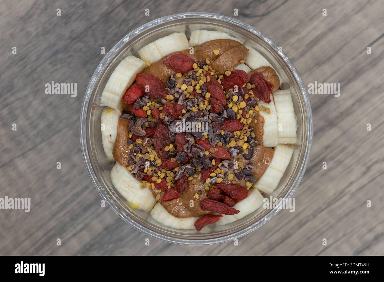 Overhead view of acai fruit bowl cacao, goji berry, and bee pollen with blended flavors to increase your immunity and better nutrition. Stock Photo