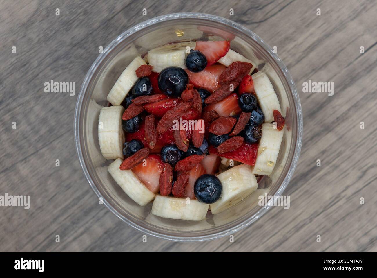 Overhead view of acai fruit bowl blueberries, strawberry, and goji berry with blended flavors to increase your immunity and better nutrition. Stock Photo