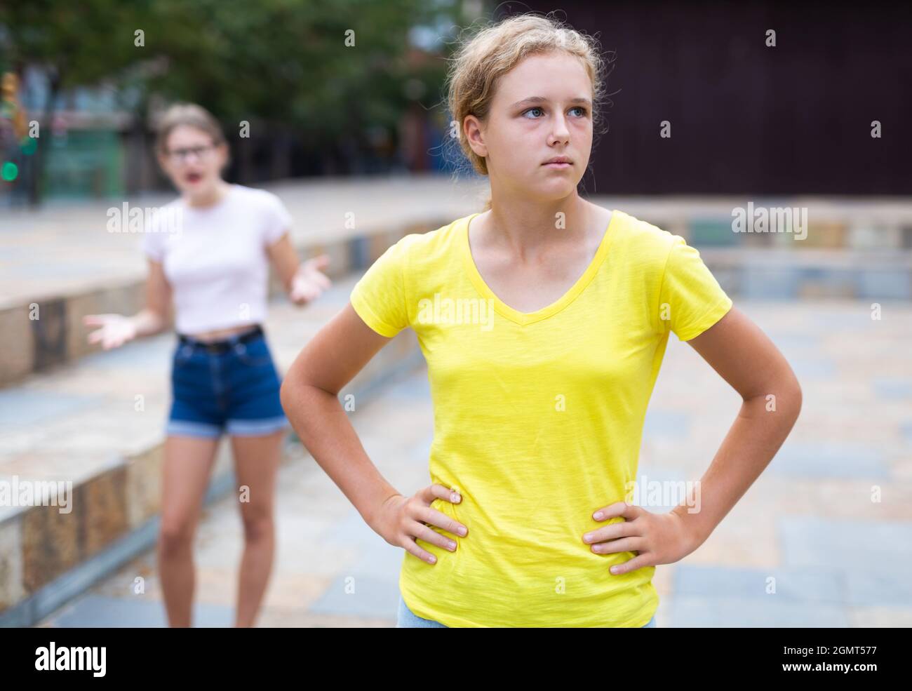 Girl was offended by the girlfriend after quarrel on street Stock Photo