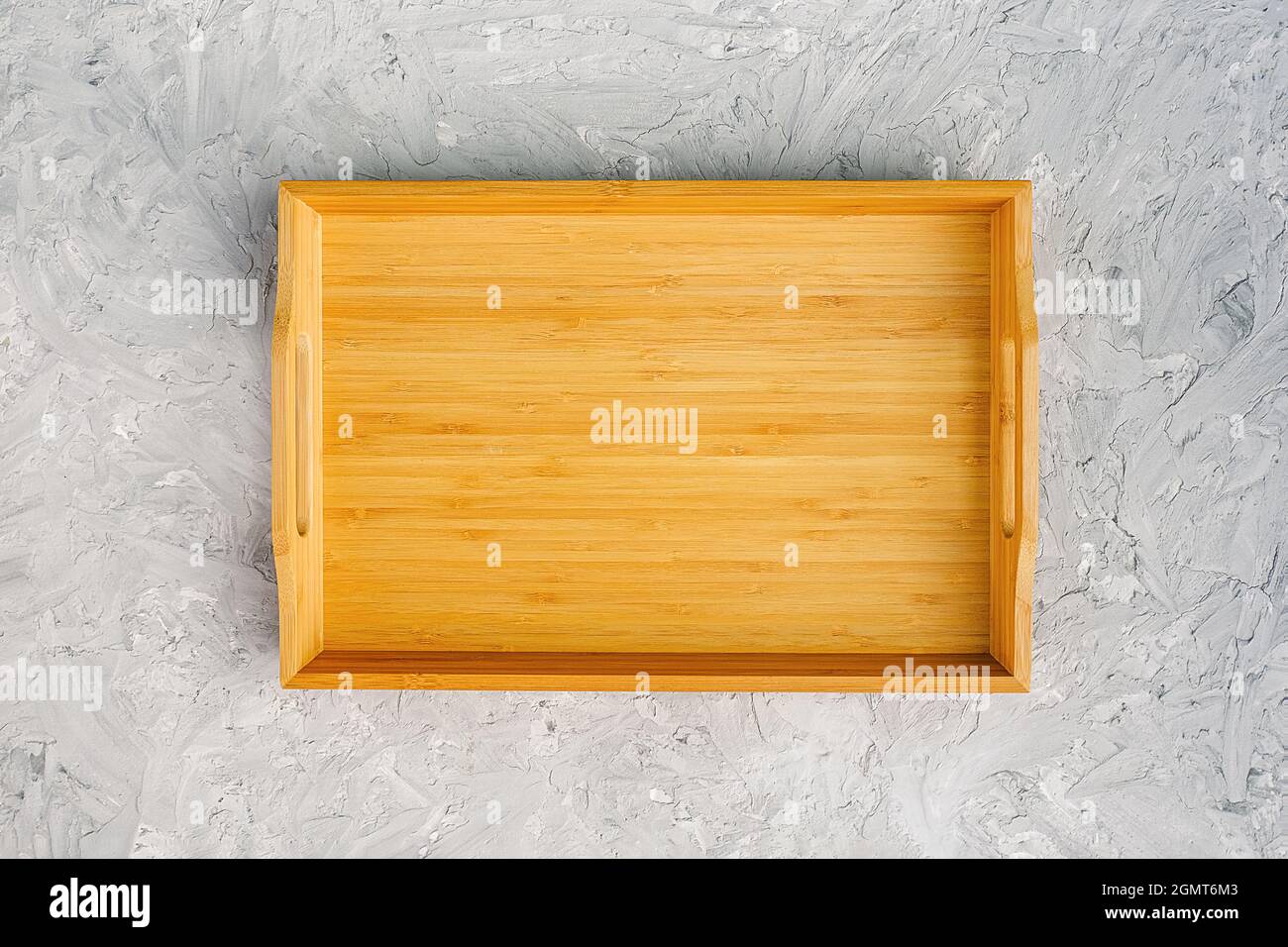 One empty wooden tray on gray stone table. Top view Mock up. Stock Photo